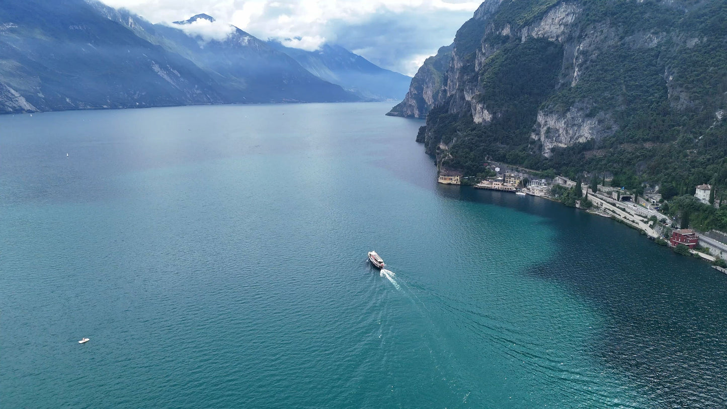 Lake Garda Boat Tracking with Light Rays and Mountains, Italy