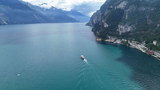 Lake Garda Boat Tracking with Light Rays and Mountains, Italy